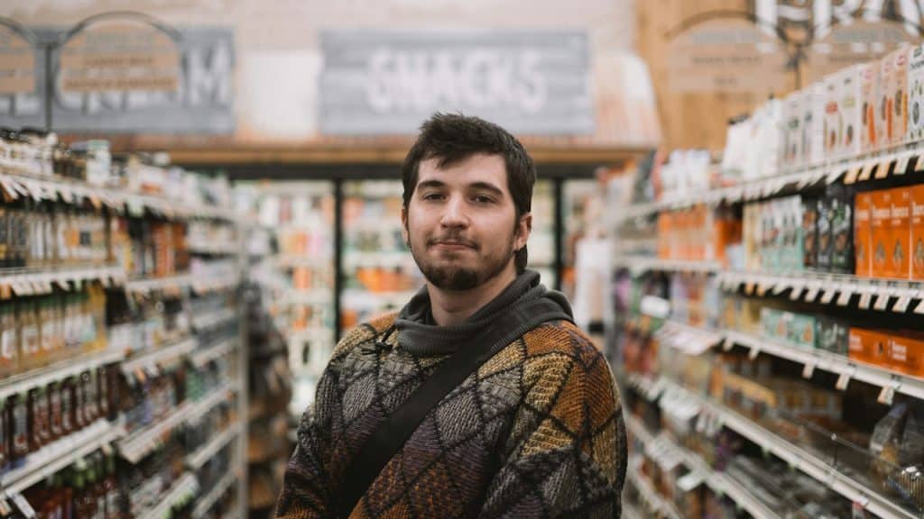A man standing on a grocery store.