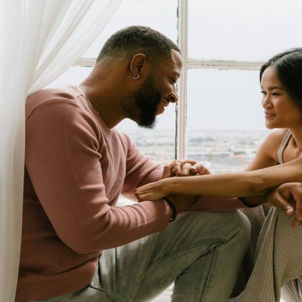 A couple flirting by the window