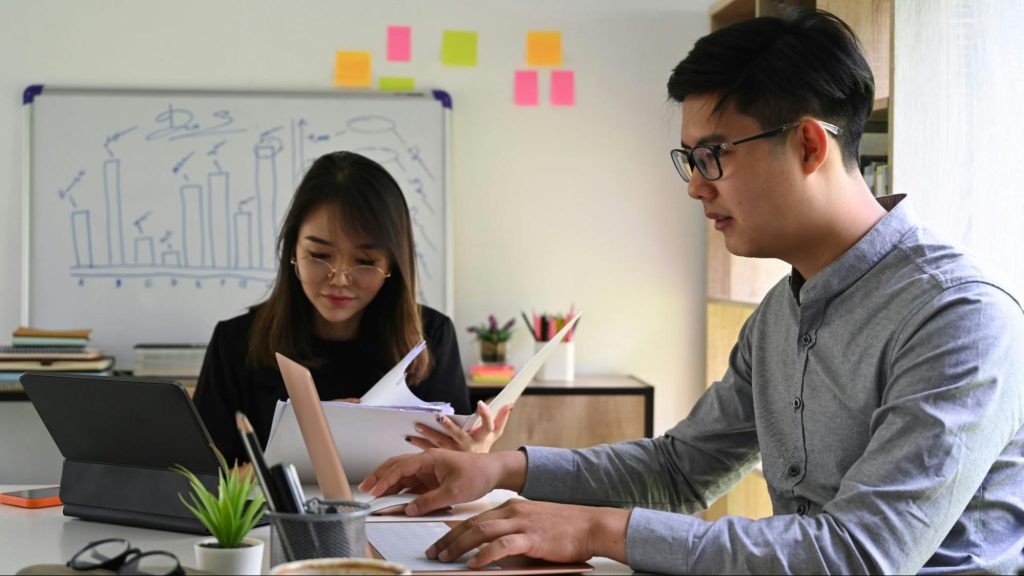 A man and woman making themselves busy to avoid talking