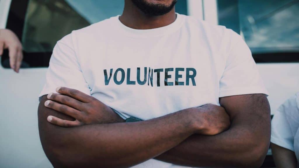 A man wearing a “volunteer” shirt