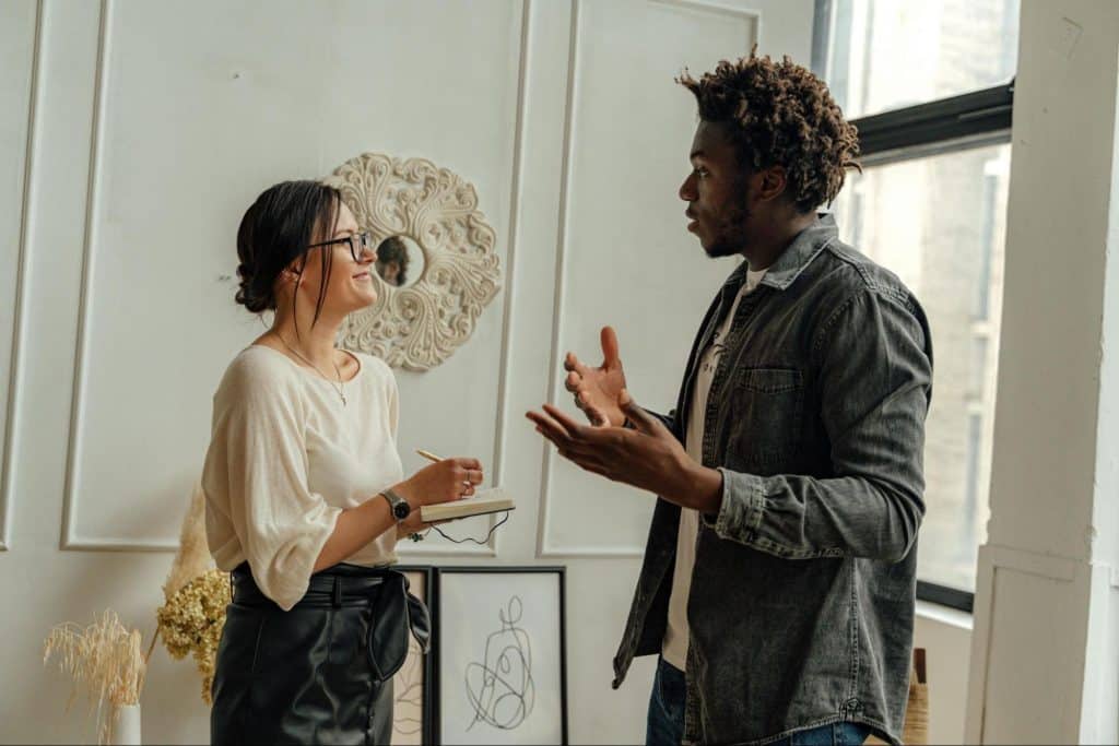 A man saying something to woman