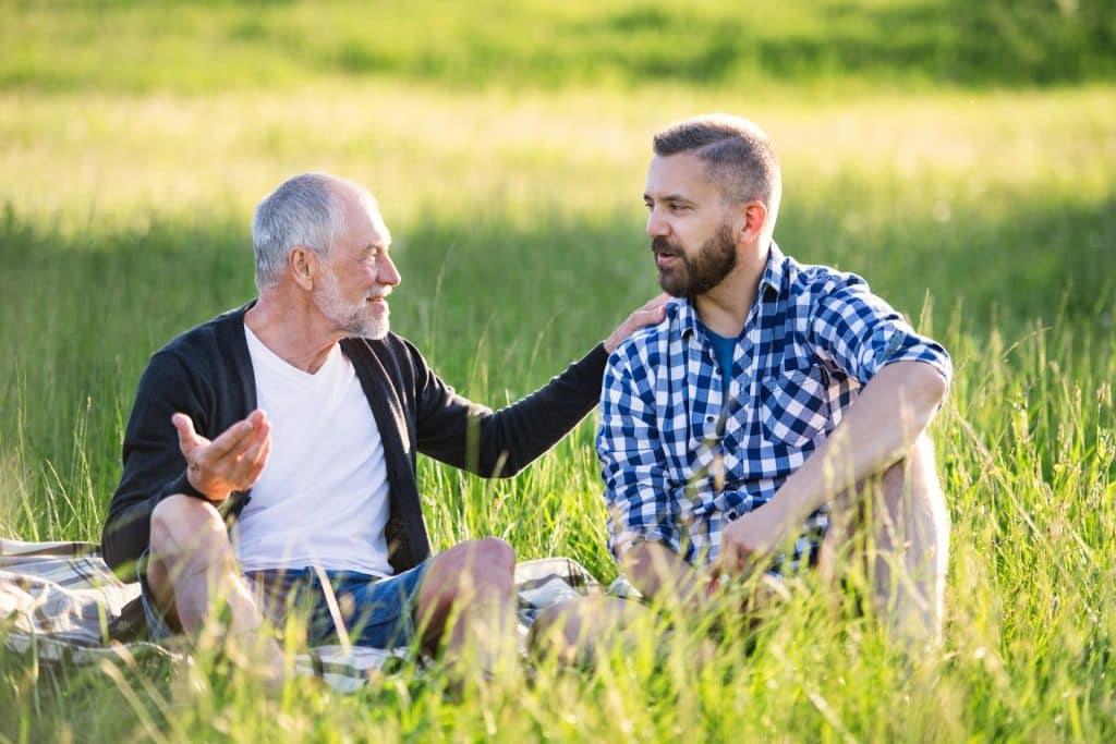 Alt text: adult man talking to his son