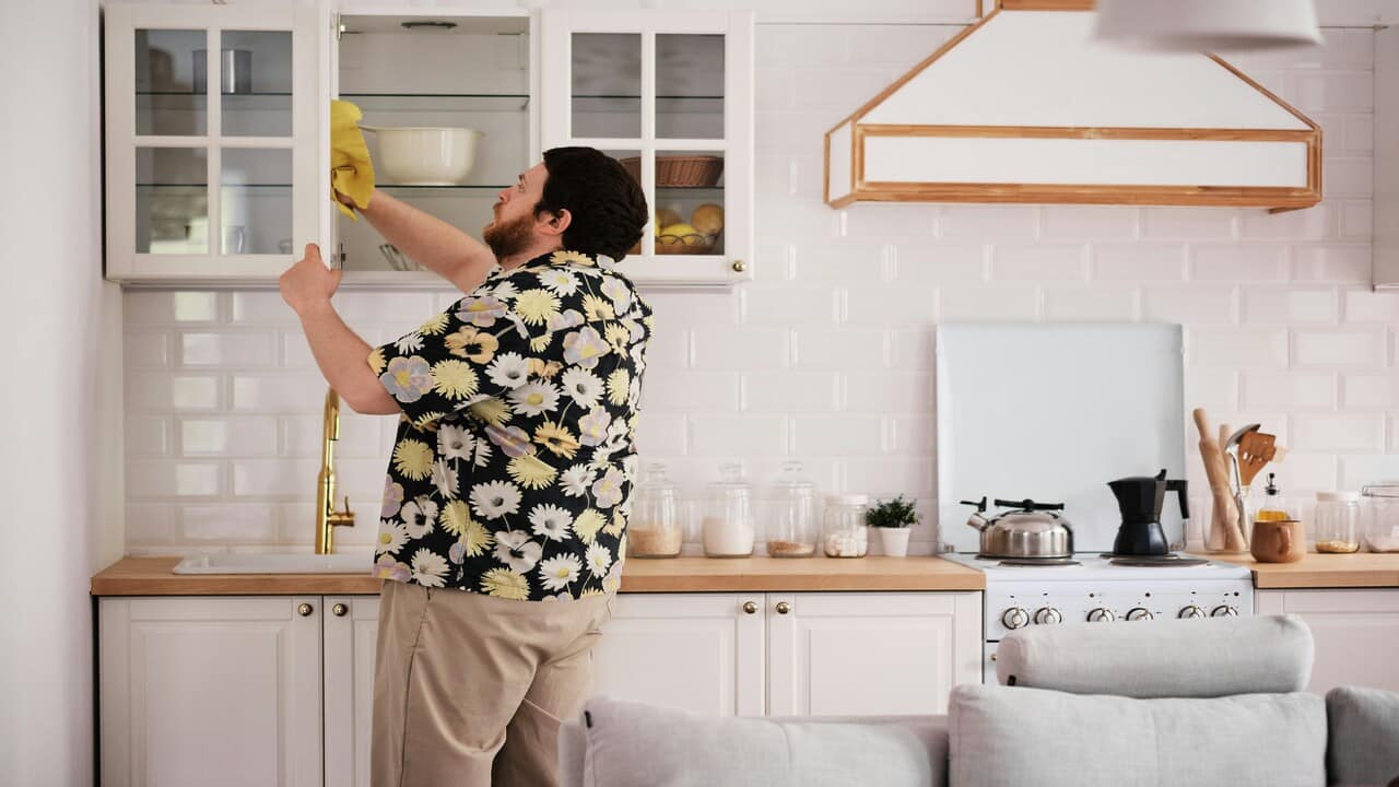 A man cleaning the kitchen