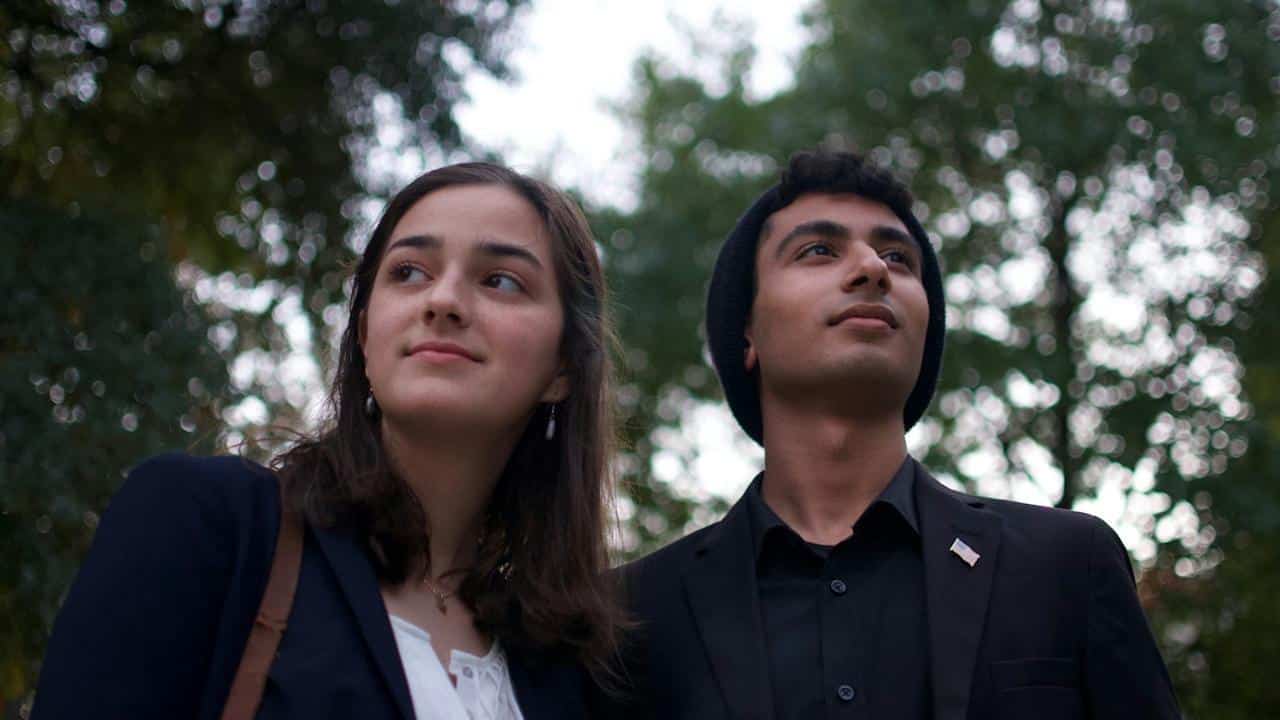 A man and woman standing outdoors.