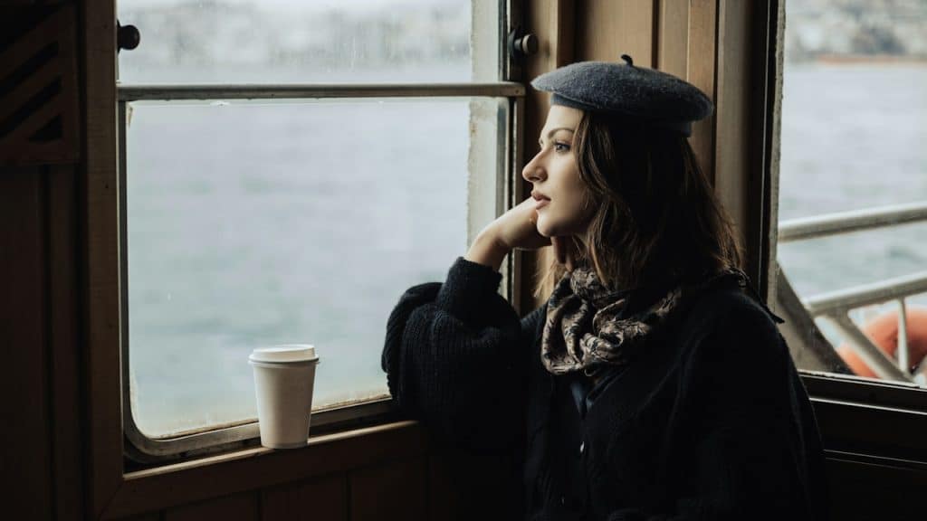 A woman looking out a window of a train.