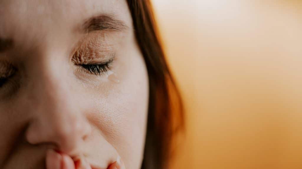 Closeup of a woman with her eyes closed.