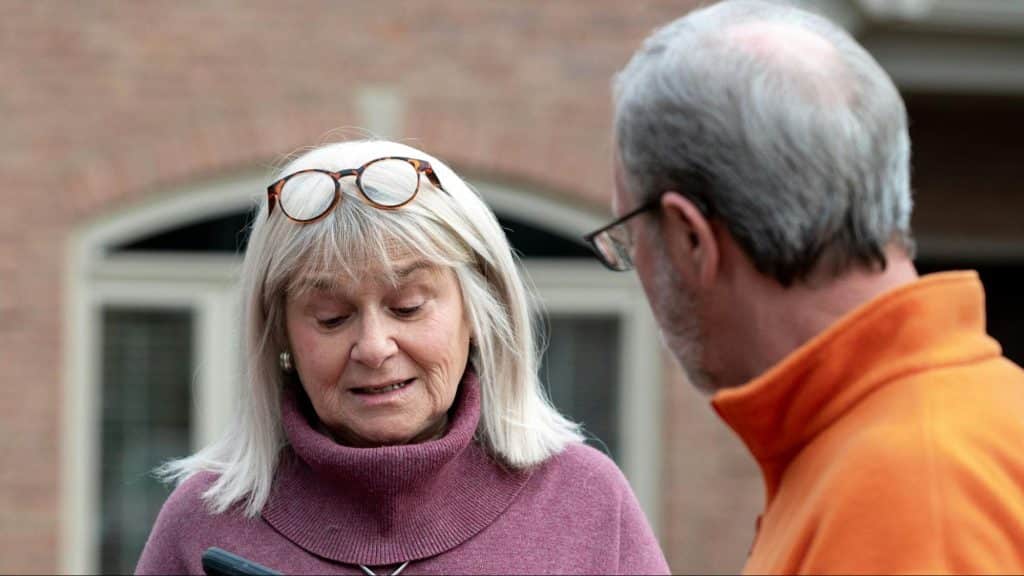 A woman holding man’s phone