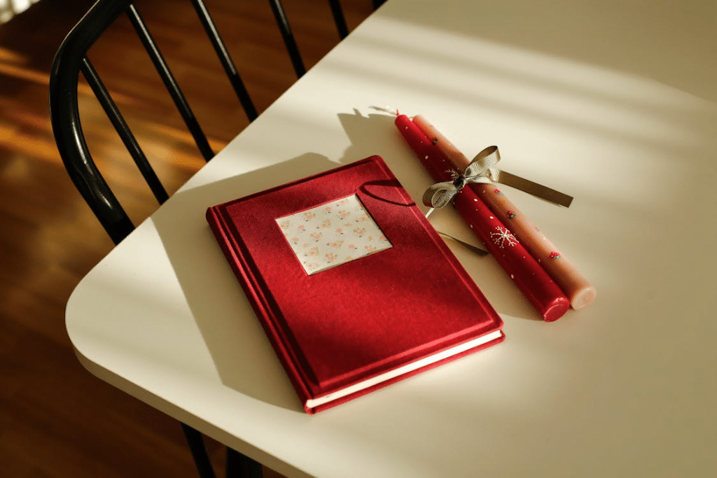 A photo of red candles and a journal