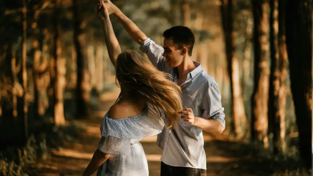 A roman couple dancing in a forest.