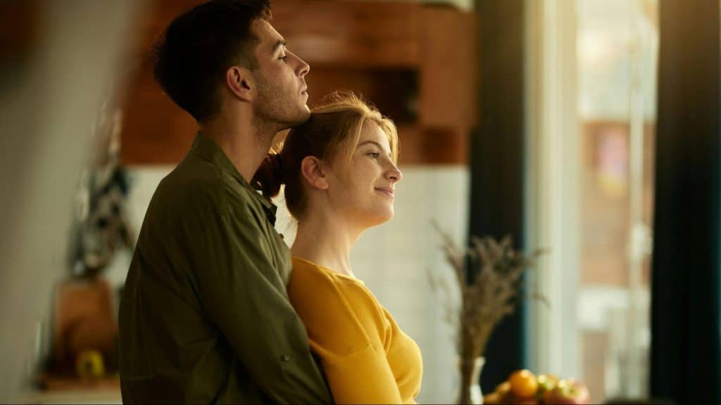 A man hugging a woman