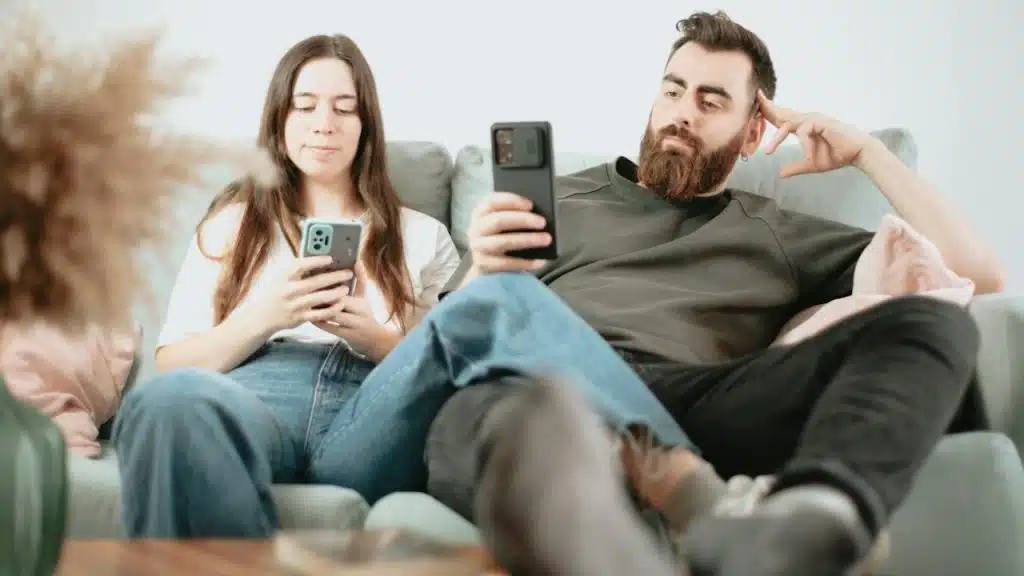 A couple sitting together on a couch.