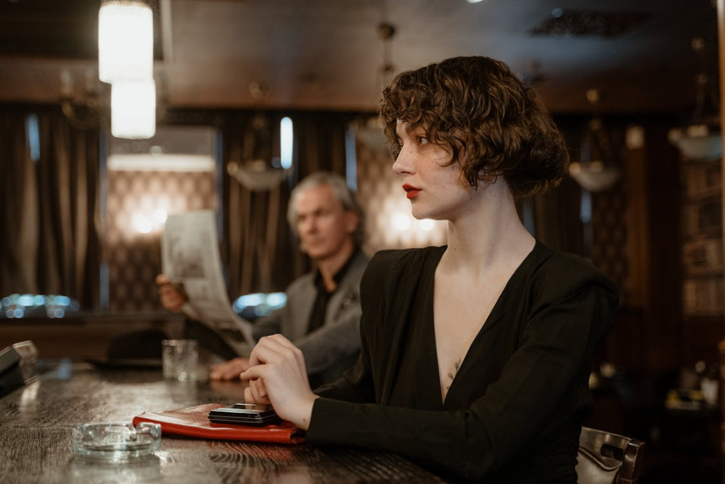 A Woman in Black Blazer Sitting at the Table
