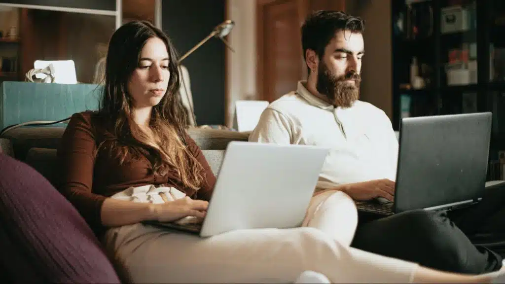 A man and  woman not talking to each other because of work