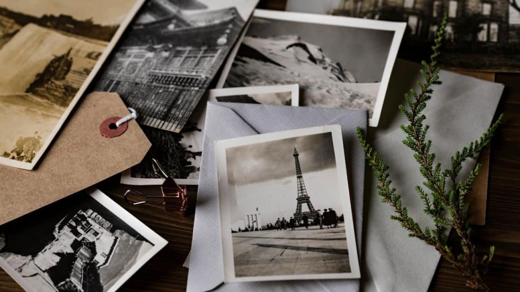 A collection of vintage black-and-white photographs on a table.