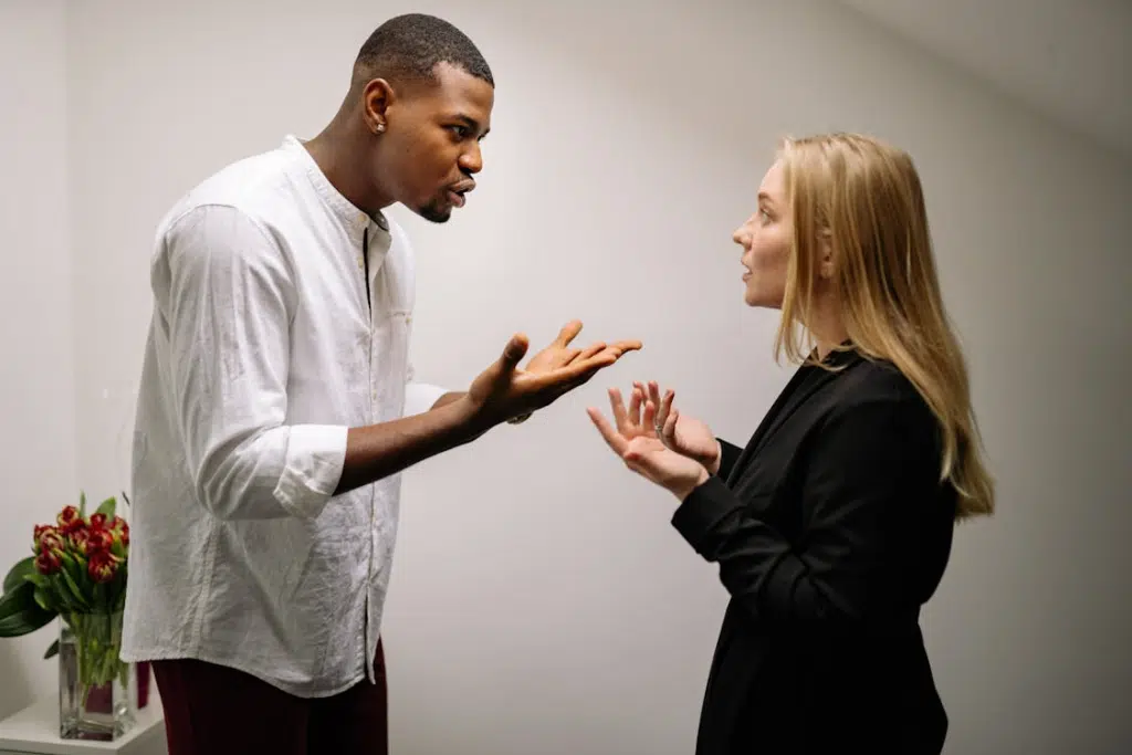 Couple in hallway arguing with each other