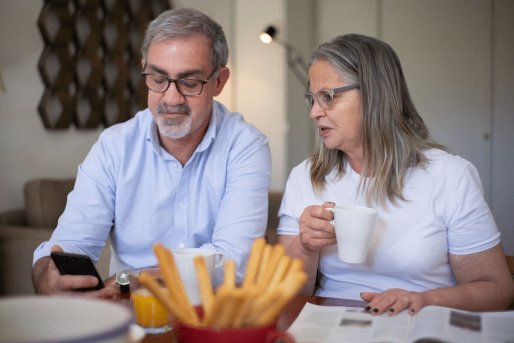 Couple using phones while sitting together