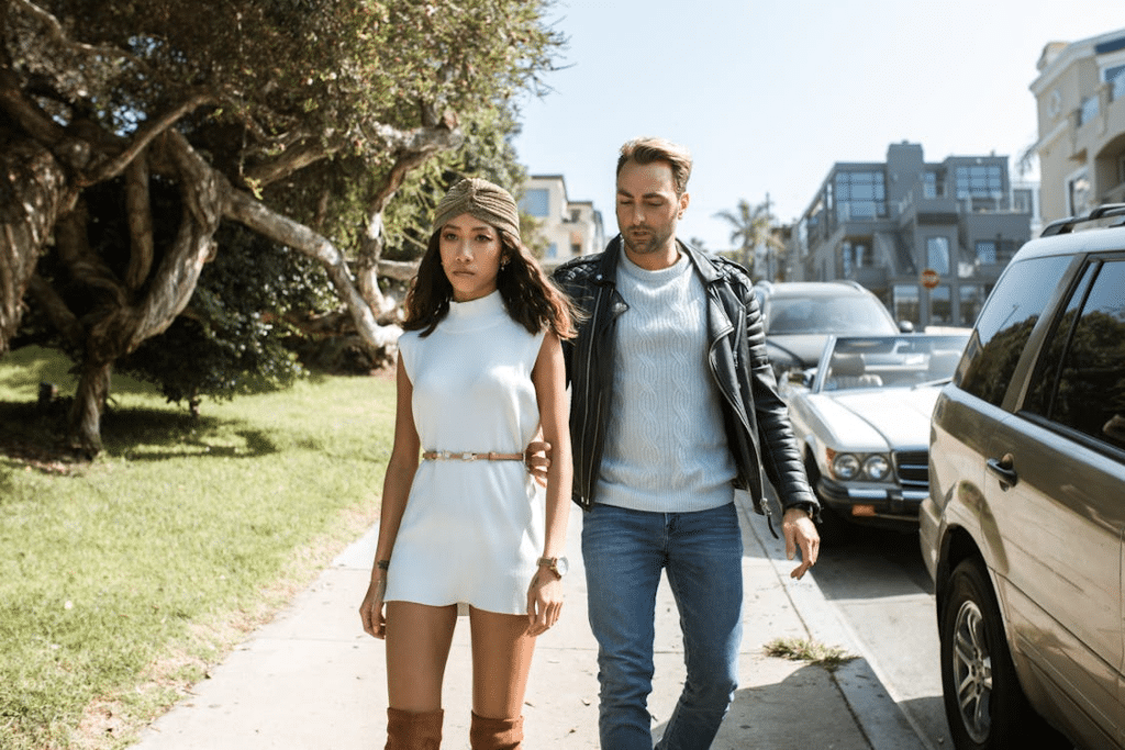 Unhappy Man and Woman Walking on a Sidewalk