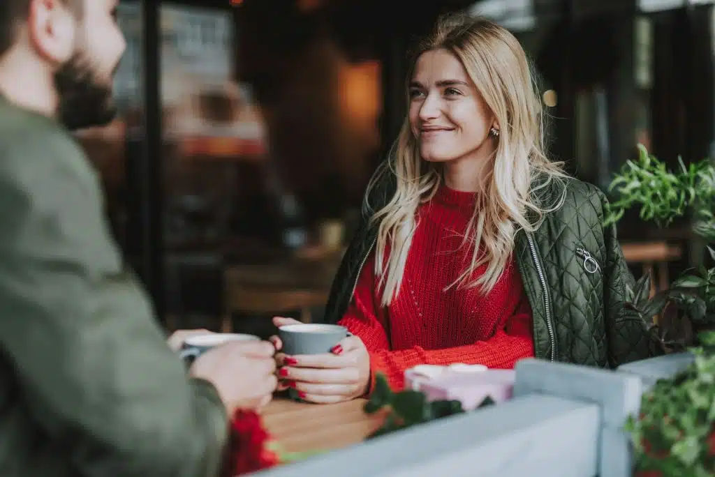 A woman holding a cup of coffee 