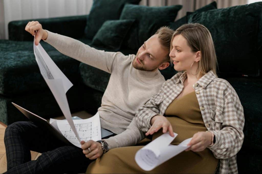 A man showing his plan to a woman