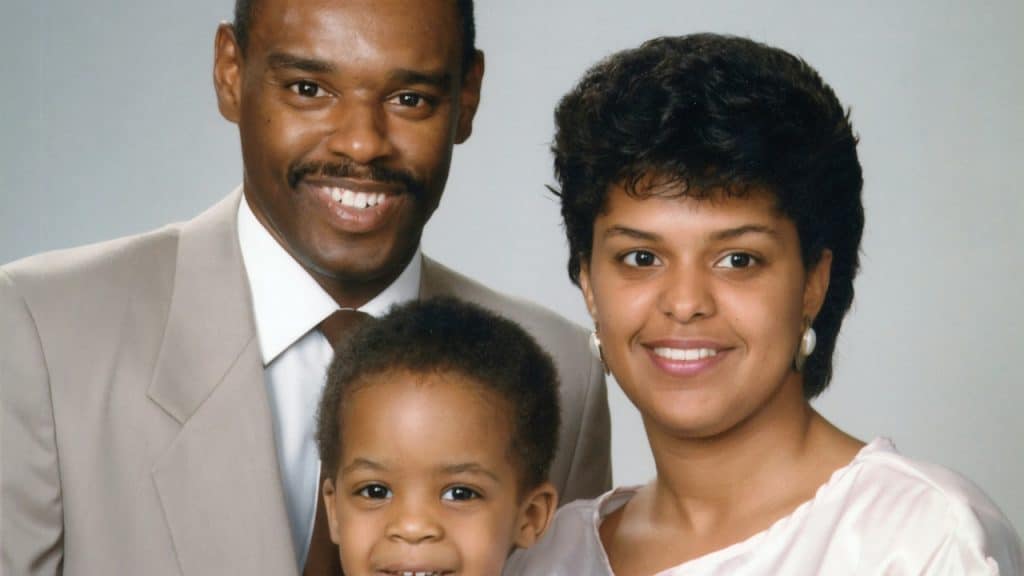 A family of three posing for a picture.