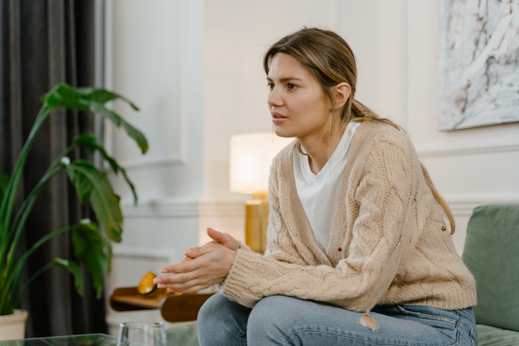 A Sad Woman Sitting on a Sofa