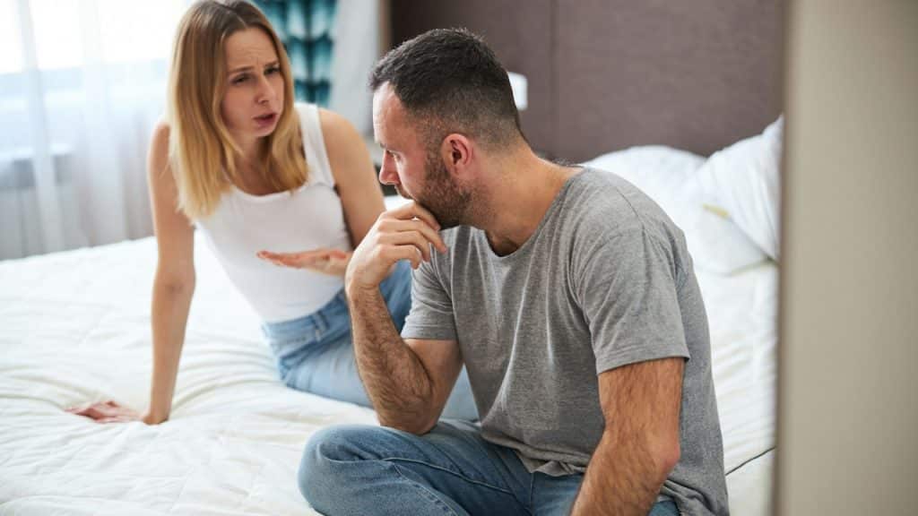 A woman is discussing something with her husband and he is listening to her with concentration.