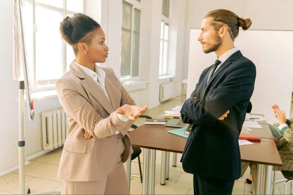 A woman trying to talk to a man