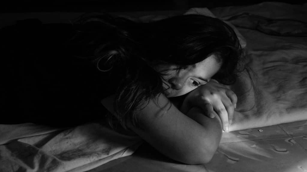 A woman looking sad in the bedroom