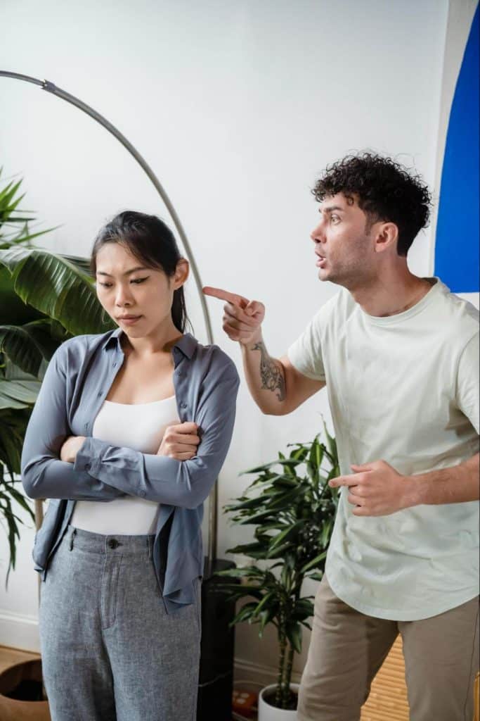 A man shouting and pointing at the woman