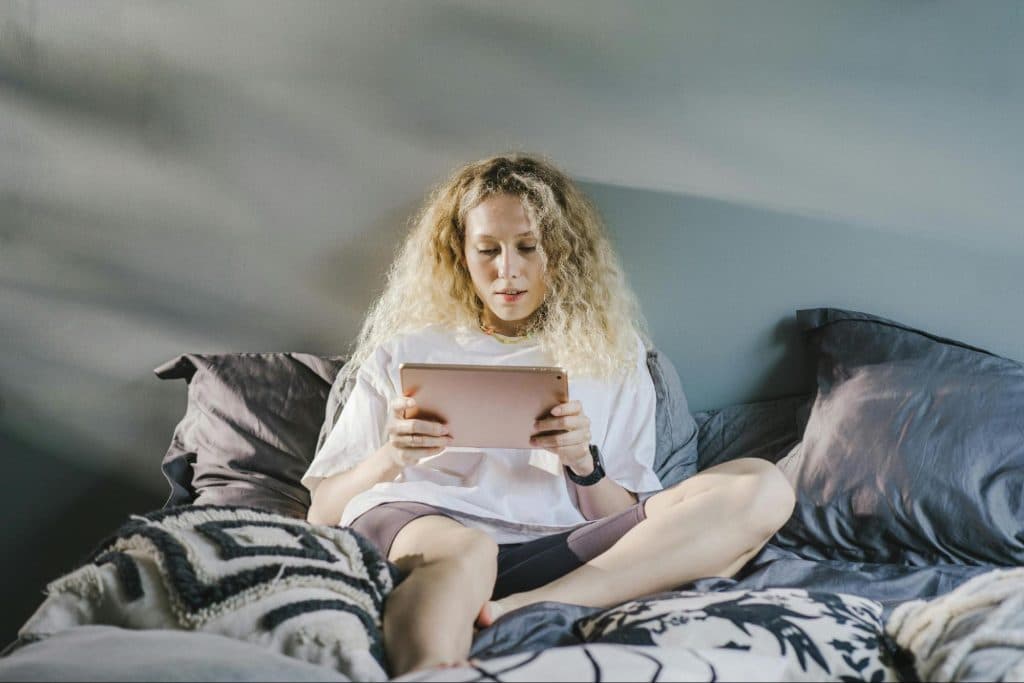 A woman alone at the bed