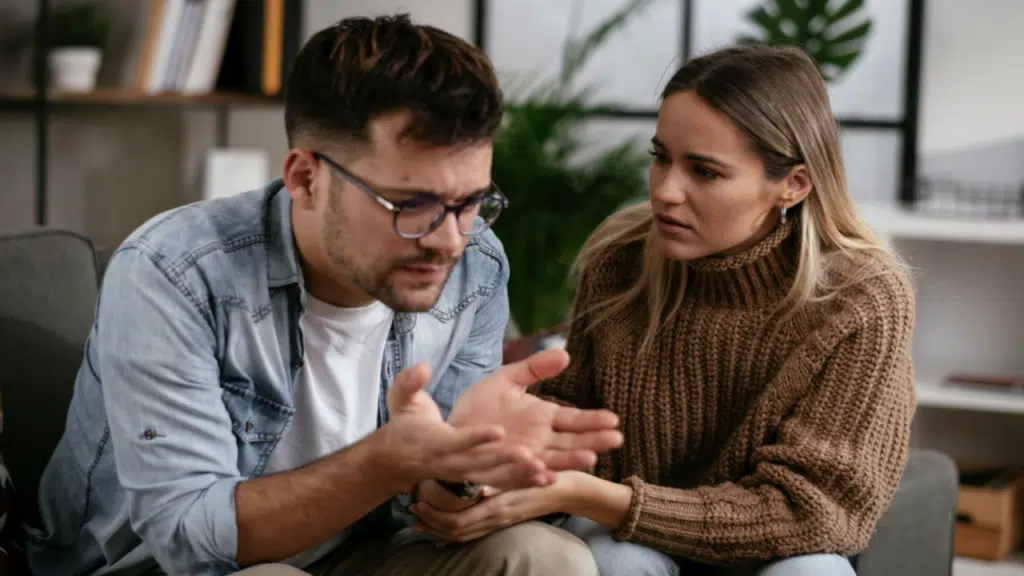 A woman apologizing to her upset husband