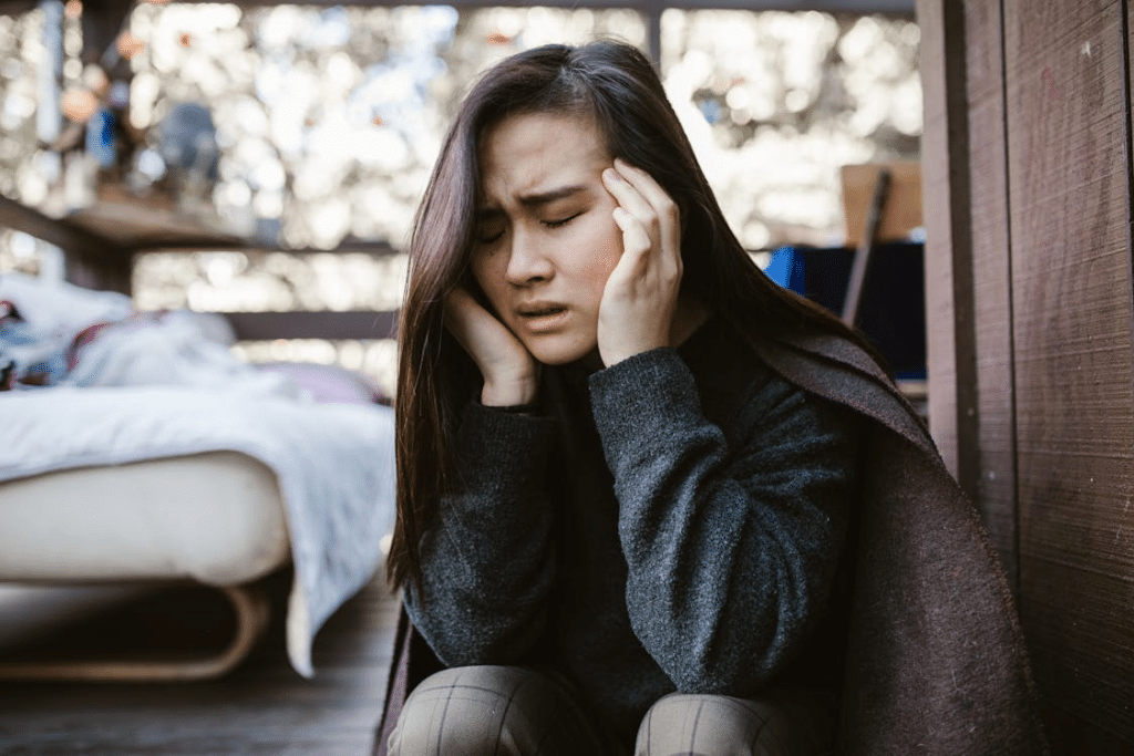 A Distressed Woman Holding her Head