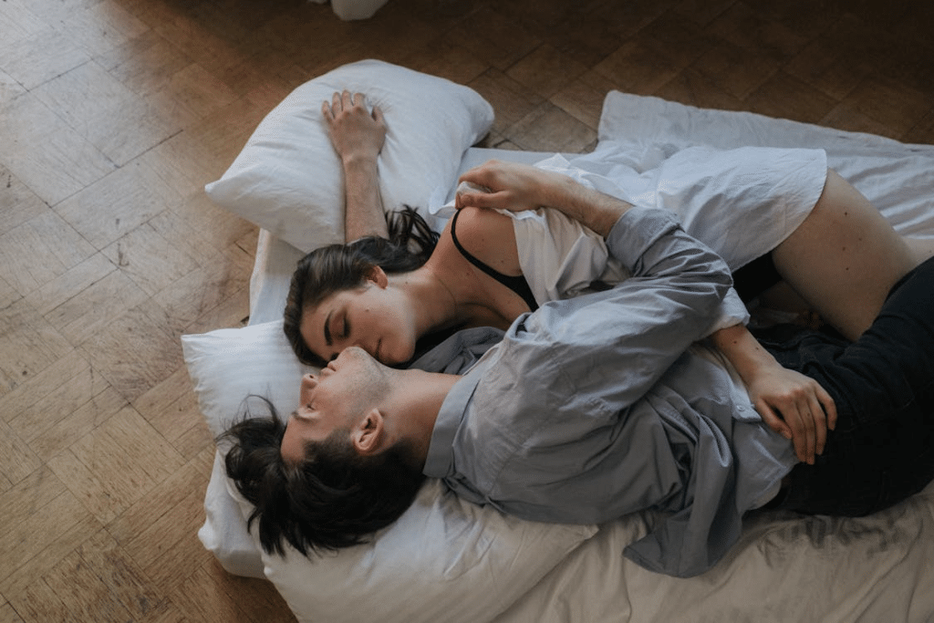 A couple cuddling in bed