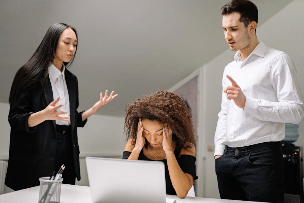 A Woman Sitting at the Table Berated by Woman and Man