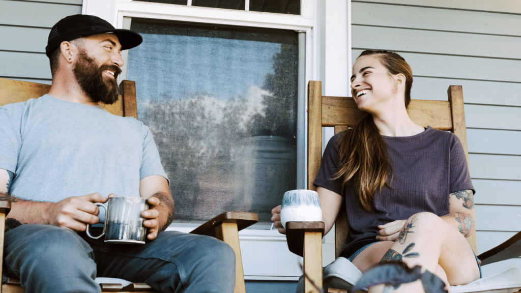 A couple talking excitedly on the porch