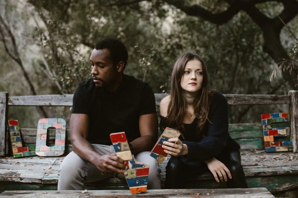 Couple in park ignoring each other