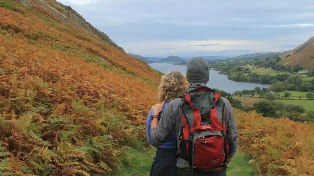 A couple standing together and stating at a picturesque view.