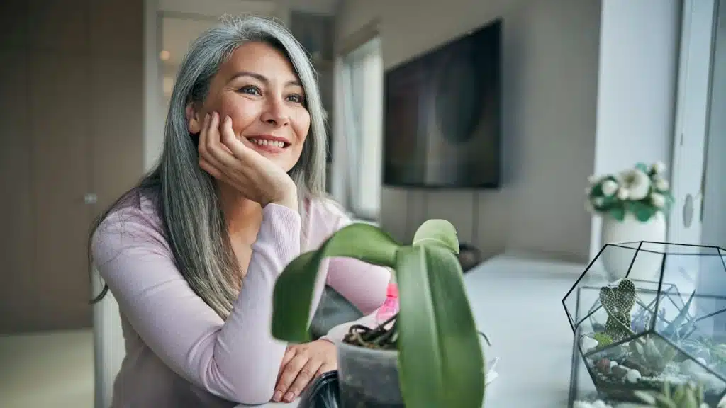 A smiling grey-haired mature woman.