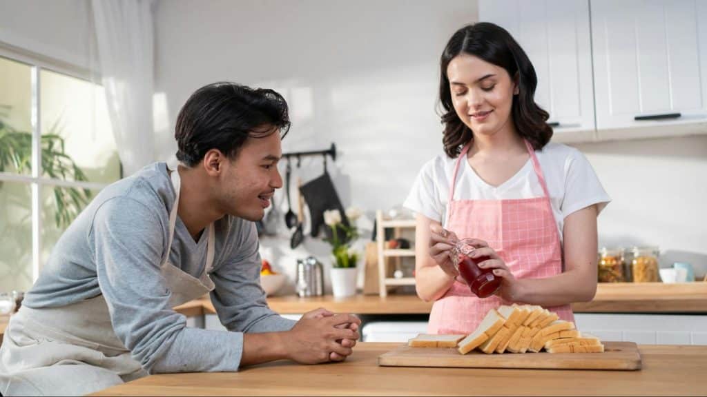 A man showing interest with what the woman doing