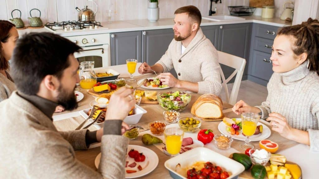 A group of friends enjoying a meal together at a dining table.
