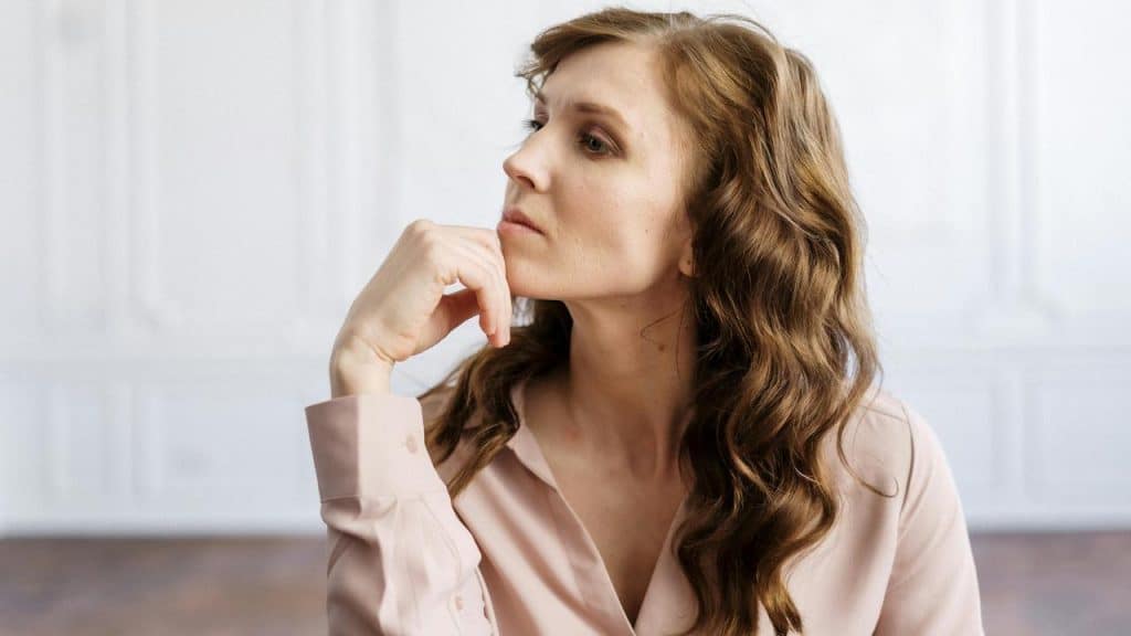 A person resting their chin on their hand, appearing thoughtful.