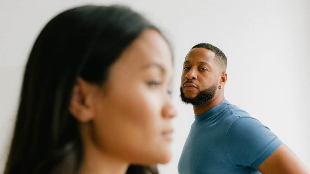 A man looking at a woman standing next to him.