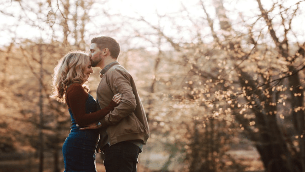 A man giving his girlfriend a forehead kiss