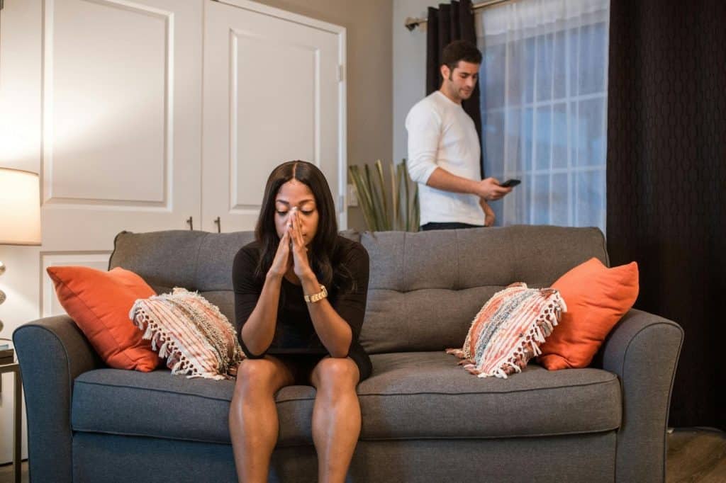 Woman thinking and a man behind her