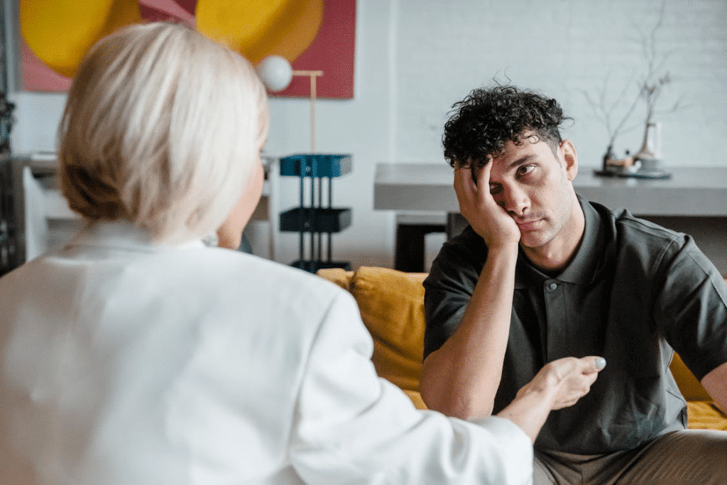 Man bored and unattentive talking to woman