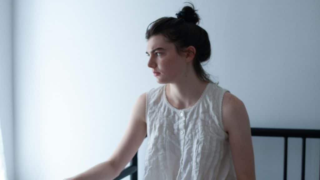 A woman sitting alone on a sofa.