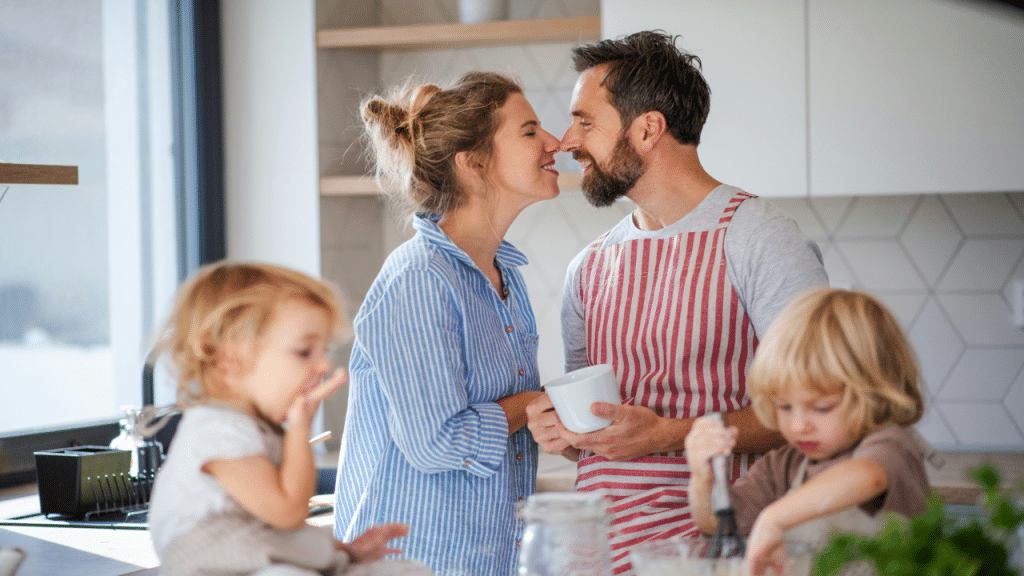 A couple kissing in the kitchen