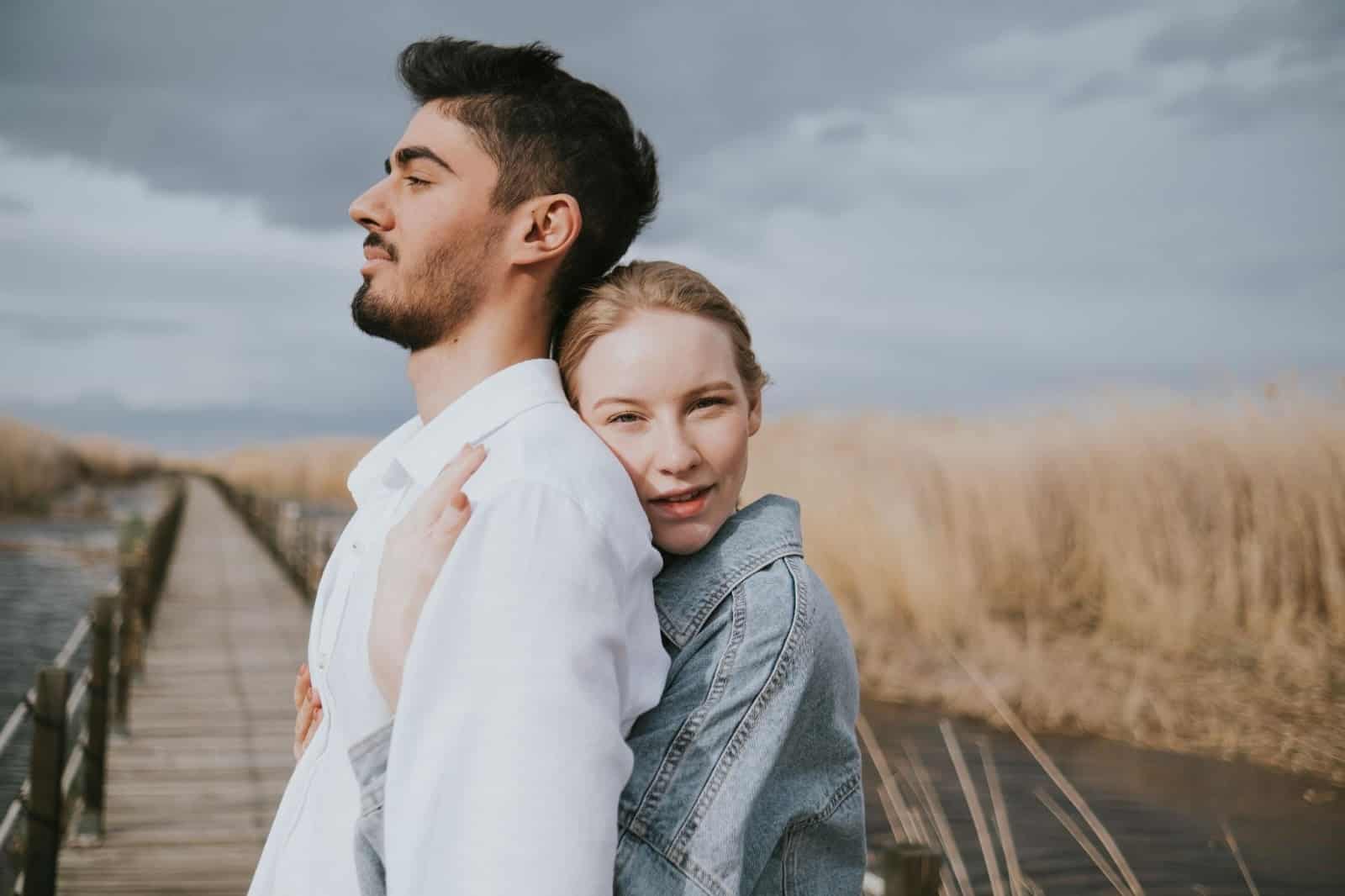 A woman hugging a man