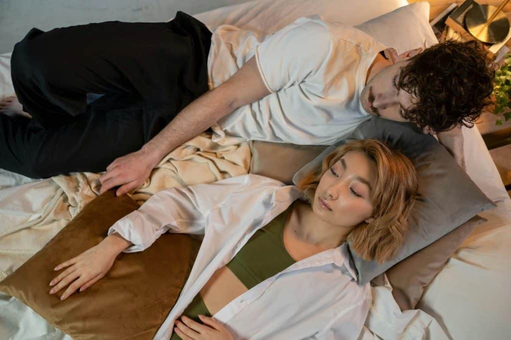 A man and woman lying on the bed
