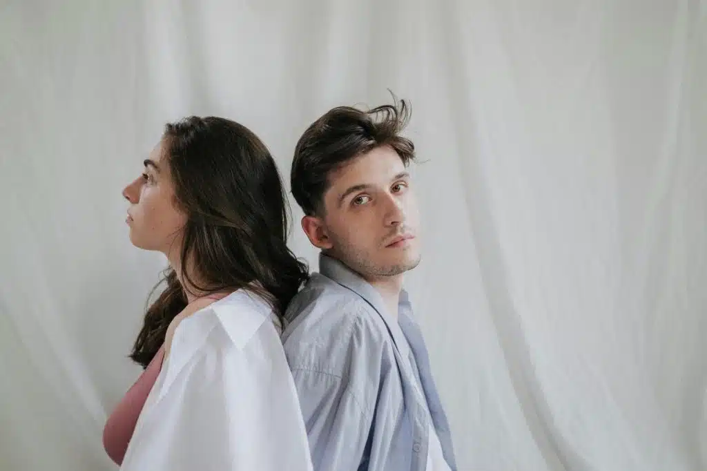 A man and woman sitting back to back